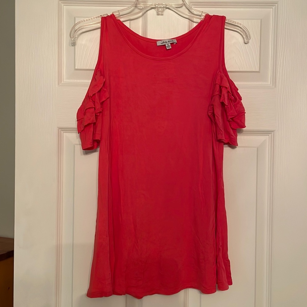 Coral colored cold shoulder top with ruffles on the sleeves